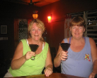 Owners of Pickled Parrot enjoying Martinis at Secret Garden Cafe both walking distance to Sunsets Rentals in Placencia